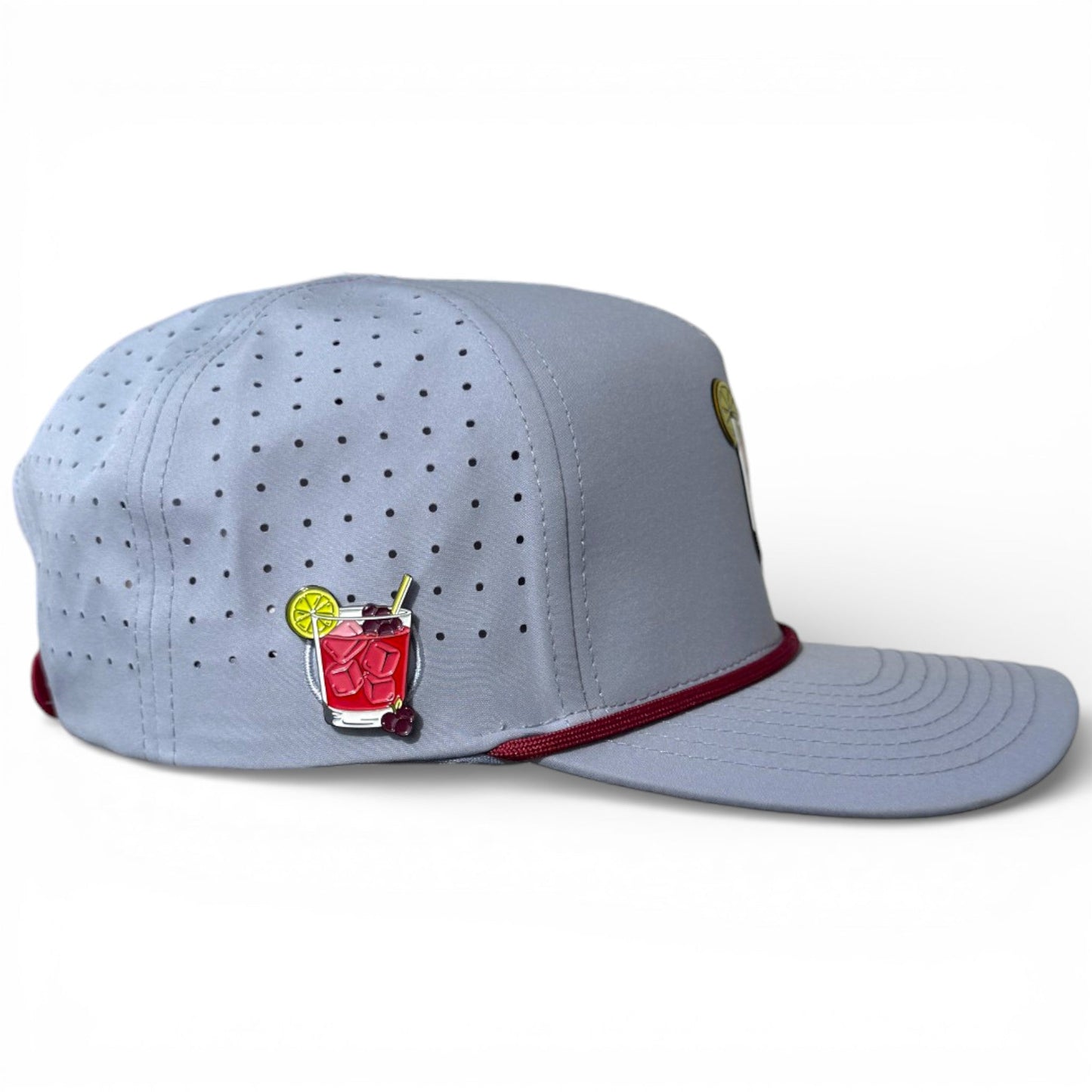 Light gray golf snapback cap with perforations and red-trimmed brim; marker holder detail