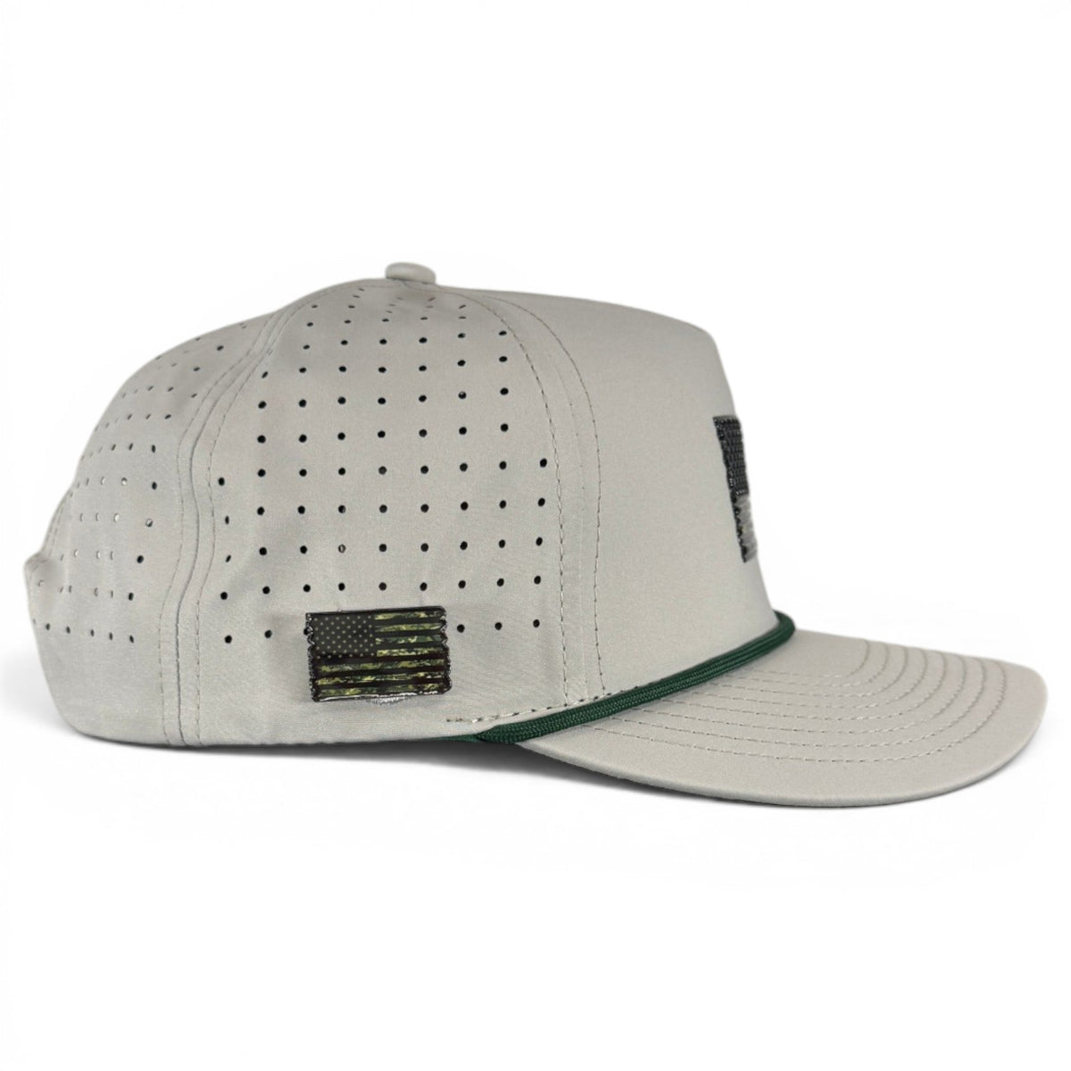 Light gray snapback golf cap, perforated front panels and green-trimmed brim with flag patch