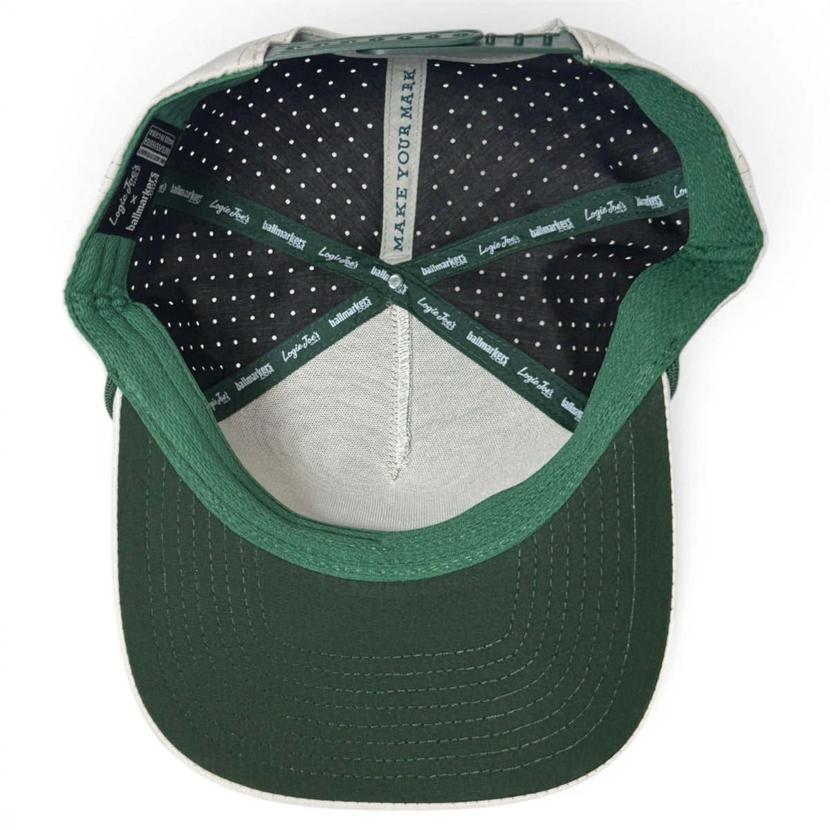 Green and dark navy plaid snapback golf cap with perforated underside and green eyelet trim