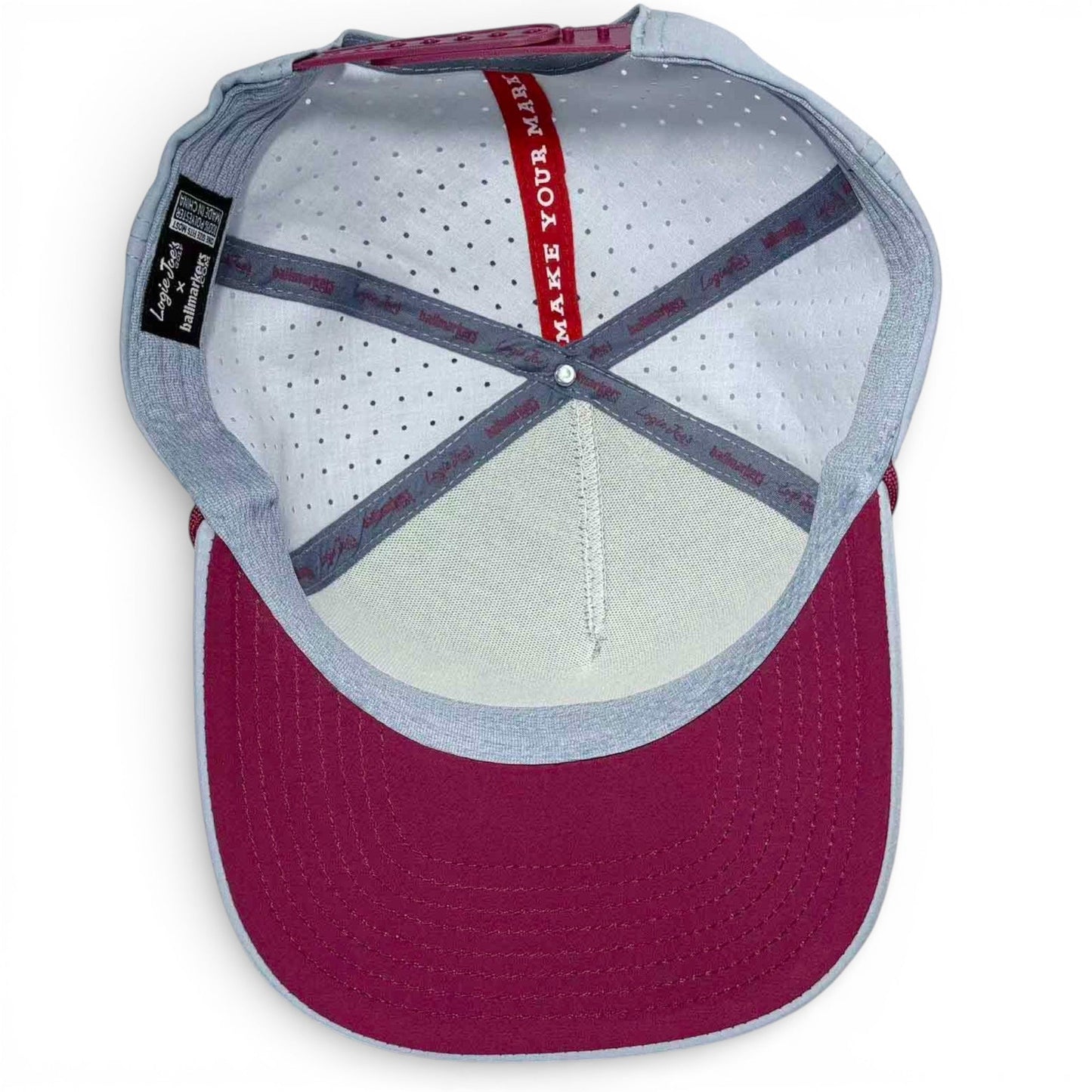 Inside view of light gray golf snapback cap with burgundy back panel and mesh crown
