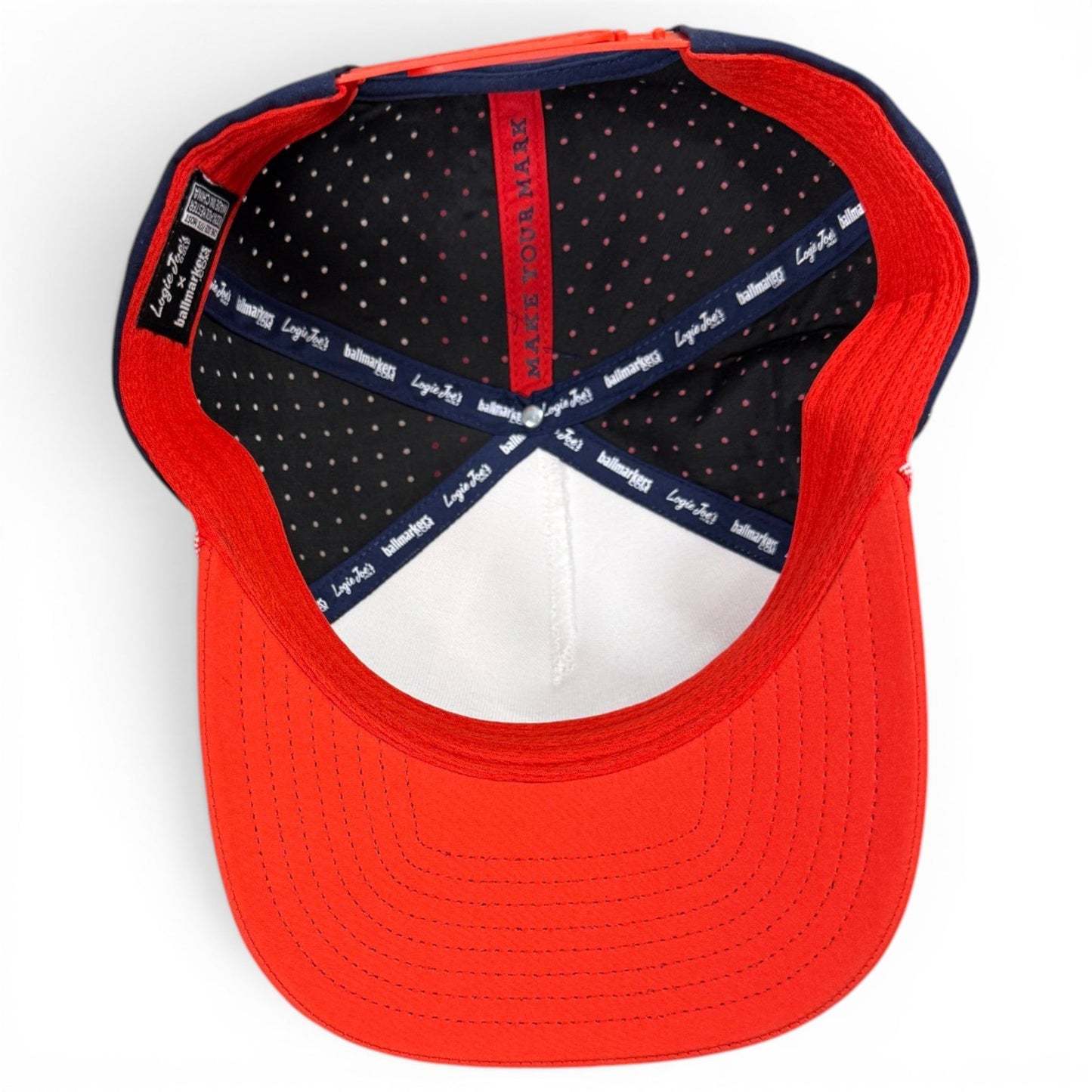 Red snapback cap with patterned inner band lining and white brim underside