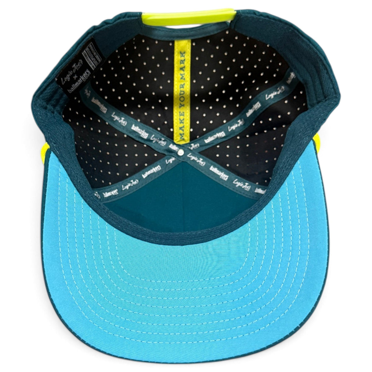 Inside view of blue snapback golf cap with black lining, printed detail, neon trim