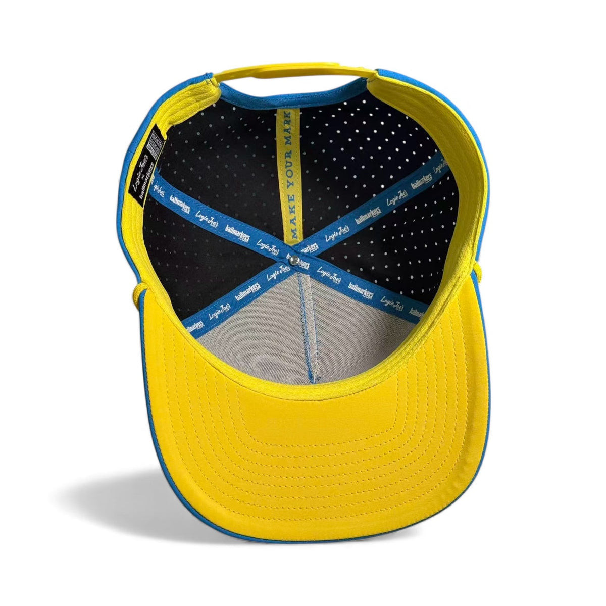 Inside view of yellow snapback cap with stitched gray panels and dark perforated lining.