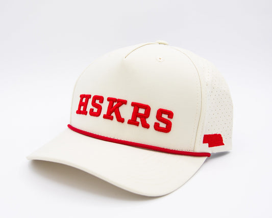 Cream baseball cap with red HSKRS logo and red trim, button on crown