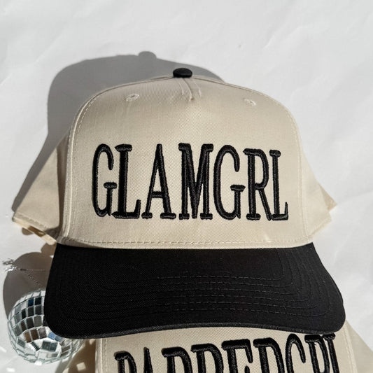 Cream and black trucker hat with GLAMGRL embroidered text on the front
