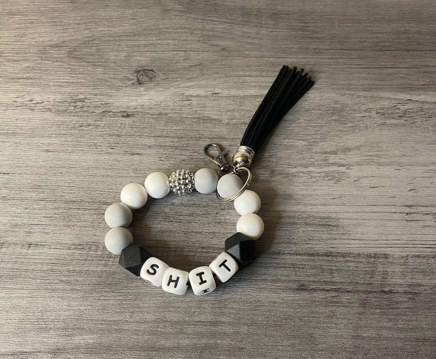 Silicone beaded wristlet with letter beads, black tassel, round keyring, white and black beads