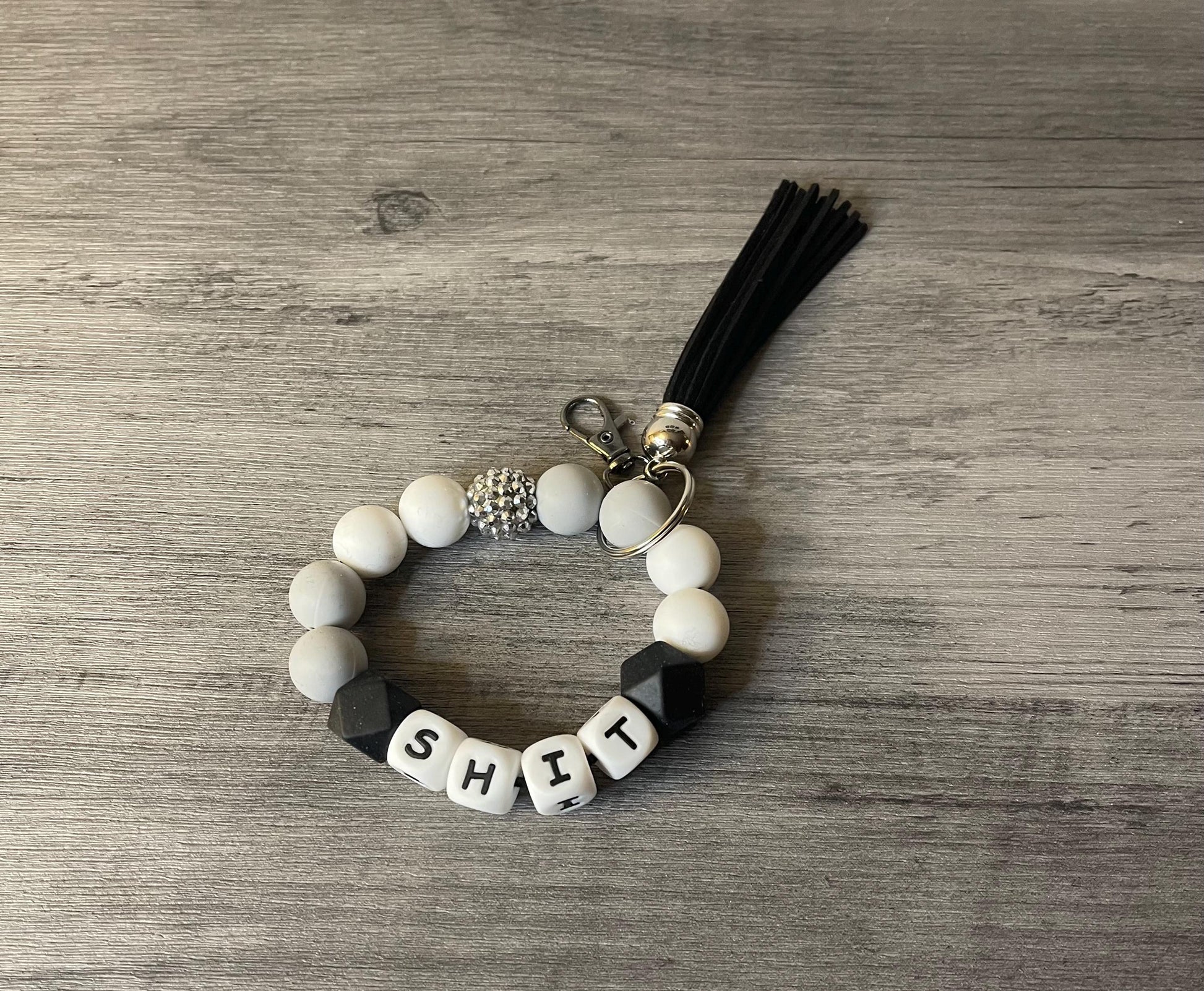 Silicone beaded wristlet with letter beads, black tassel, round keyring, white and black beads