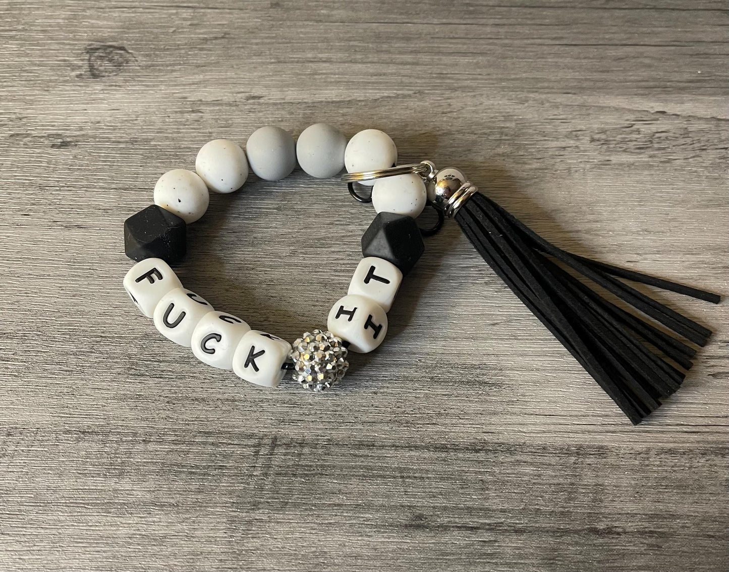 Silicone beaded wristlet with letter beads and black tassel, keyring, black and cream beads