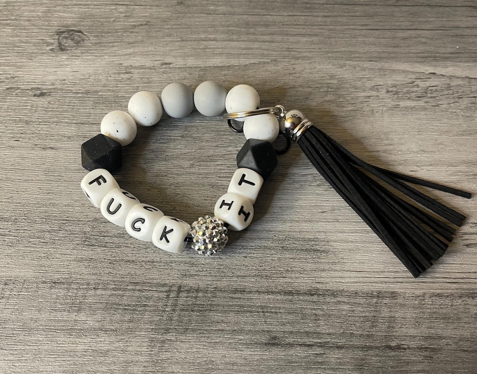 Silicone beaded wristlet with letter beads and black tassel, keyring, black and cream beads