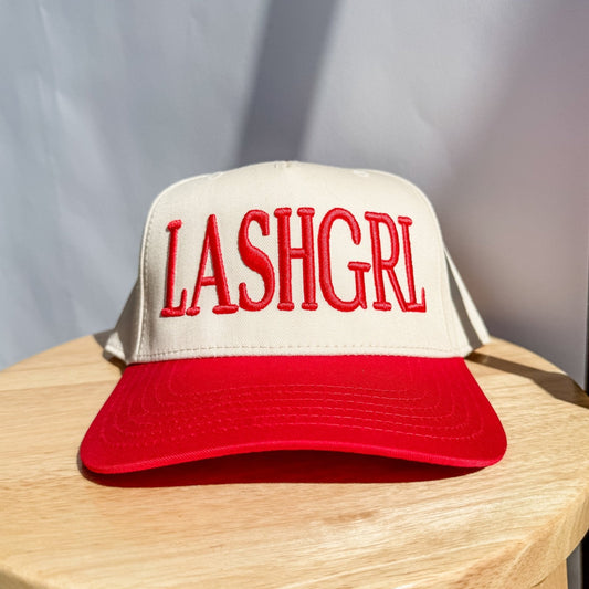 Cream and red trucker hat with embroidered red lettering on front panel
